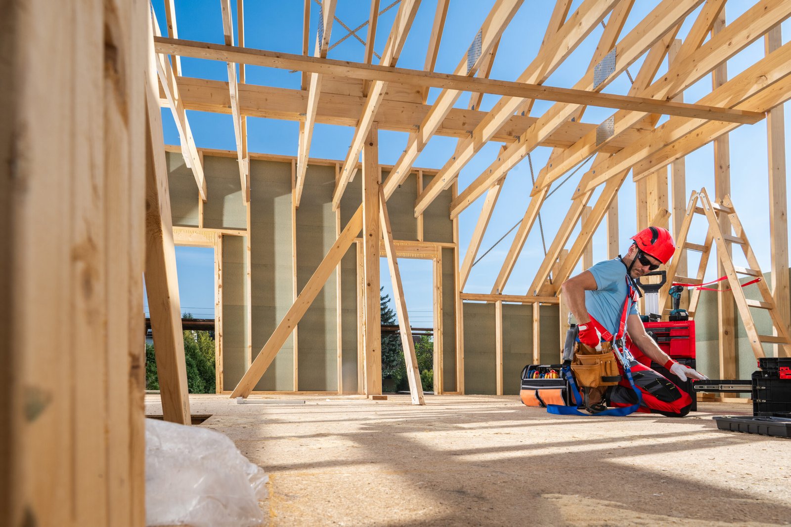 Construction worker inspecting wood framing