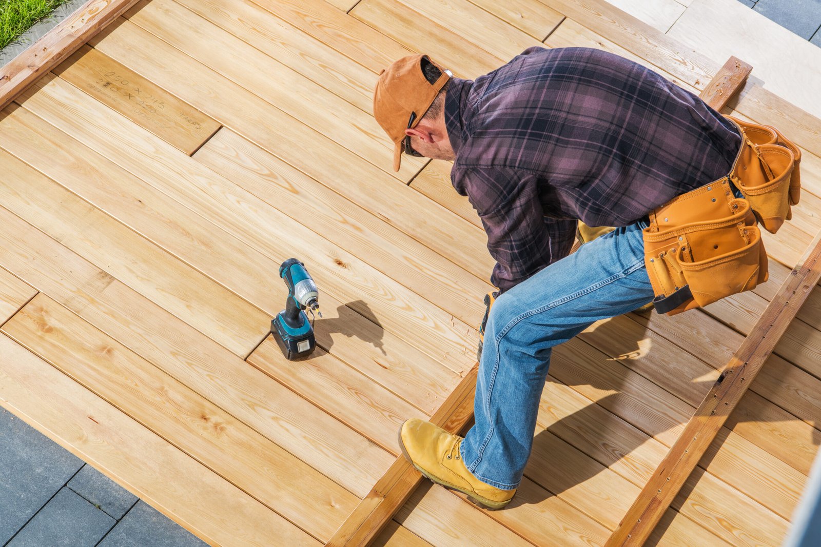 Man building wooden patio decking